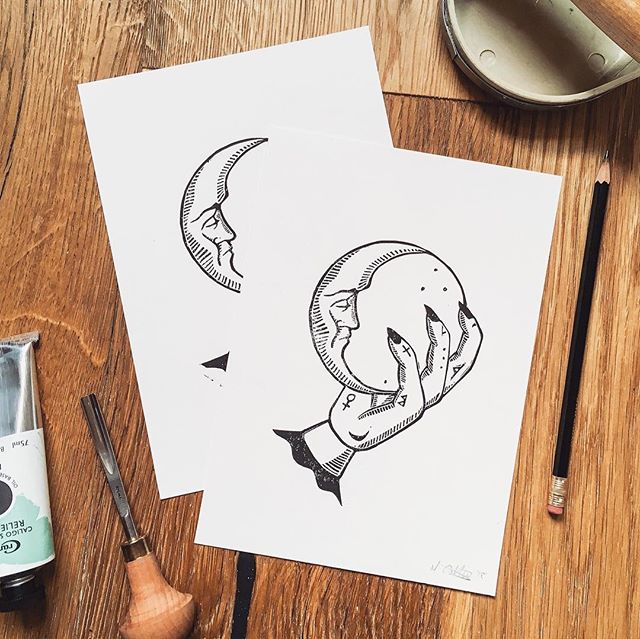 Lino print of a hand clutching a crystal ball with a crescent moon