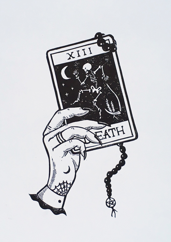 Linoprint of a hand holding the death tarot card