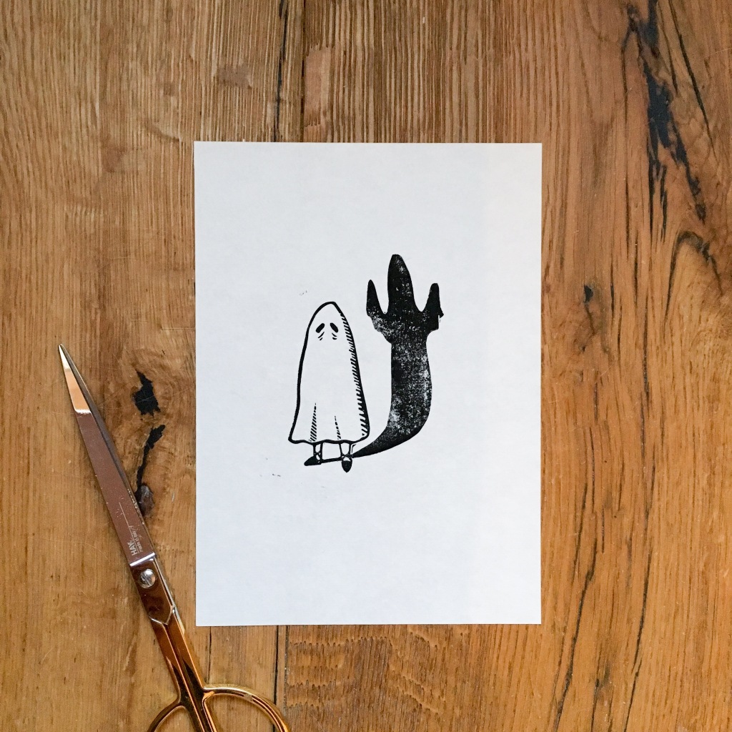 Linoprint of a sheet ghost with a shadow