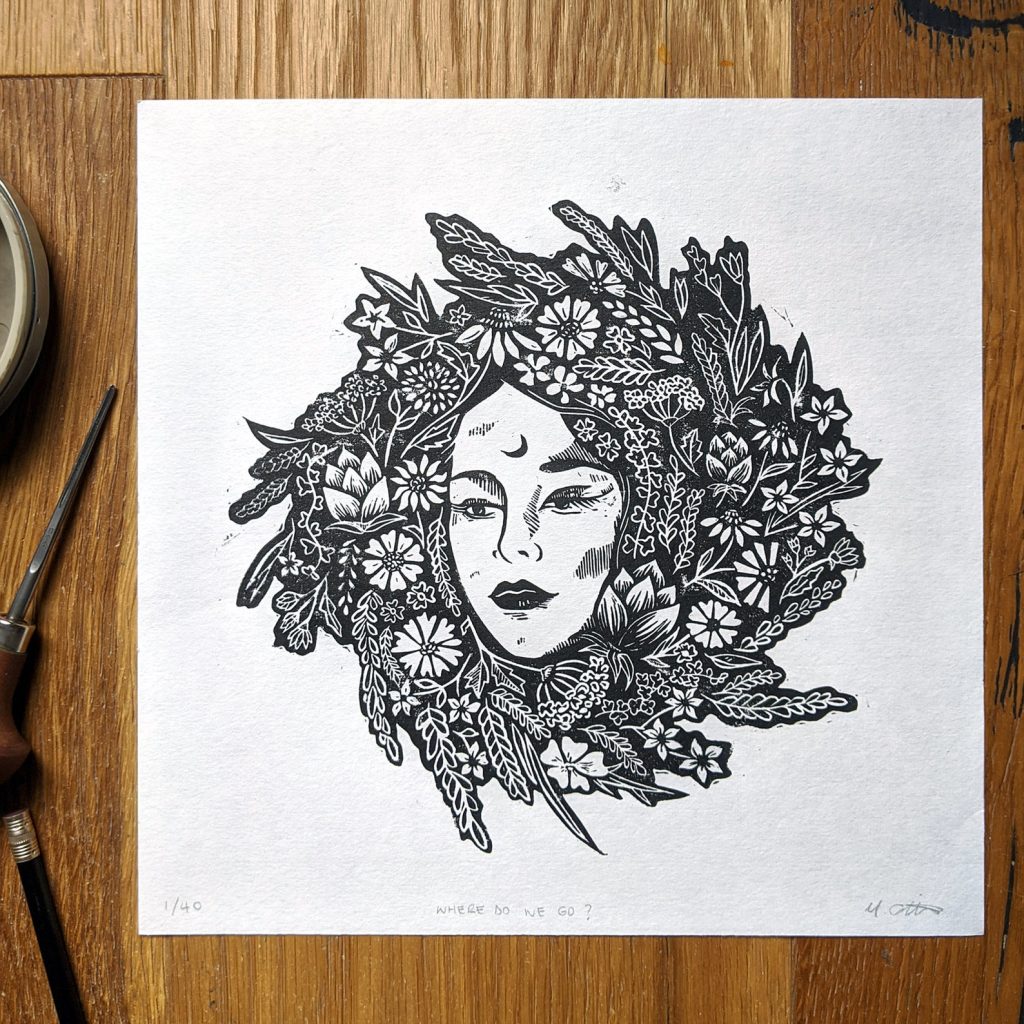 Linoprint of a woman's face wreathed in many flowers